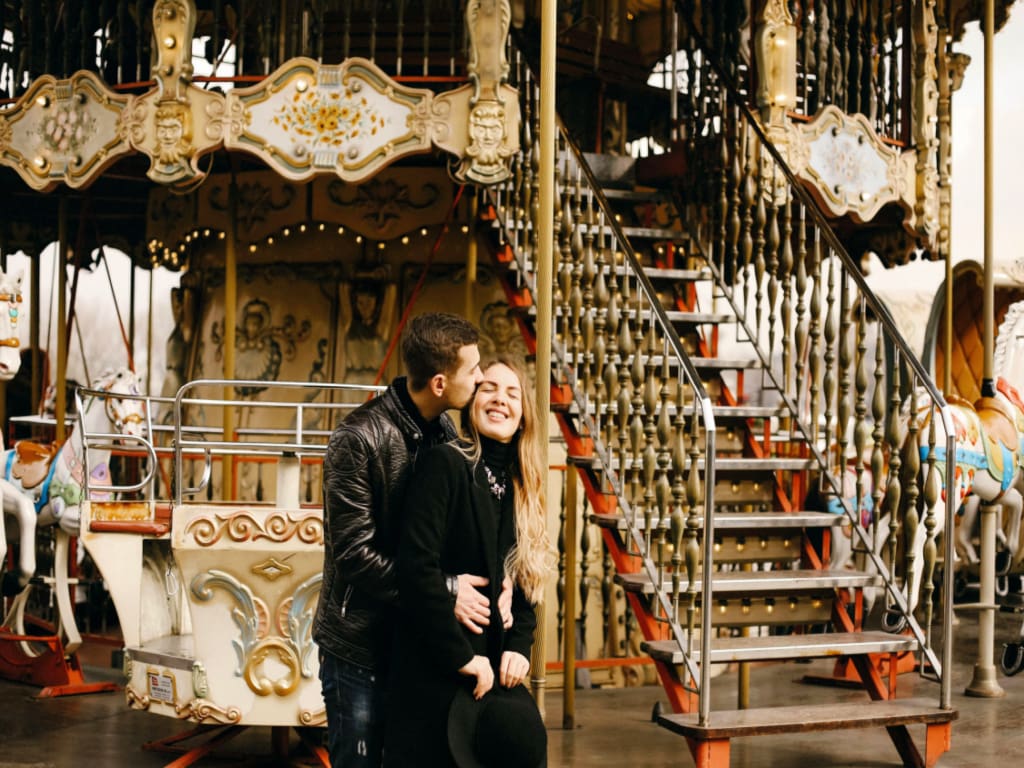 Romantic Couple Hugging at a Carousel Near the Eiffel Tower