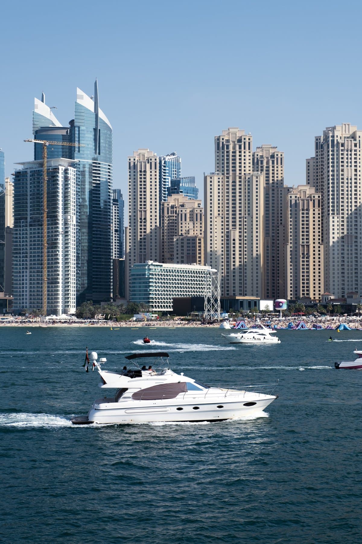 white yacht sailing in Dubai, United Arab Emirates