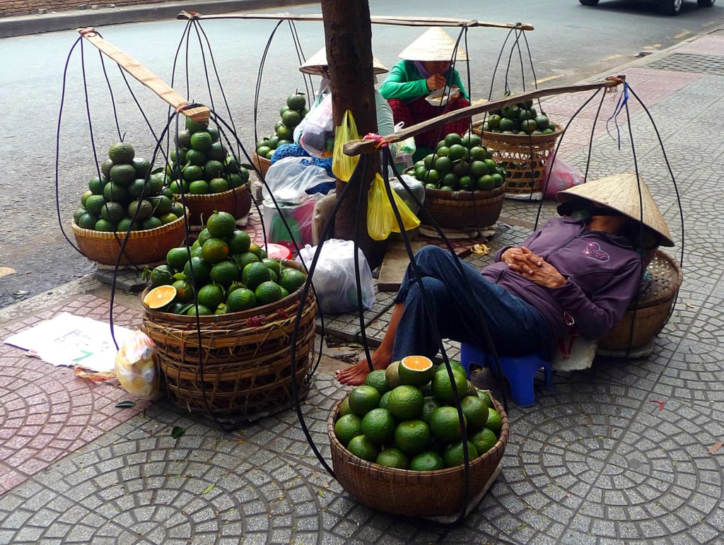 Poeple on the street selling pomelo fruit in Vietnam