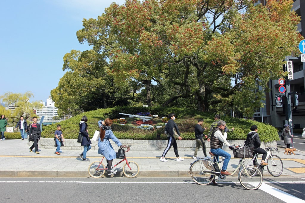 Tourists walking and cycling in Hiroshima Peace Park