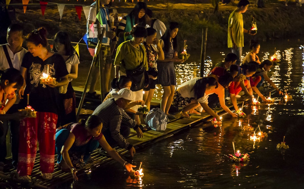 Thai people setting their candle-lit krathongs in Krabi