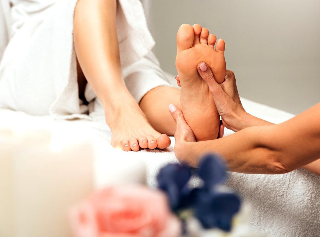 A masseur doing a foot massage