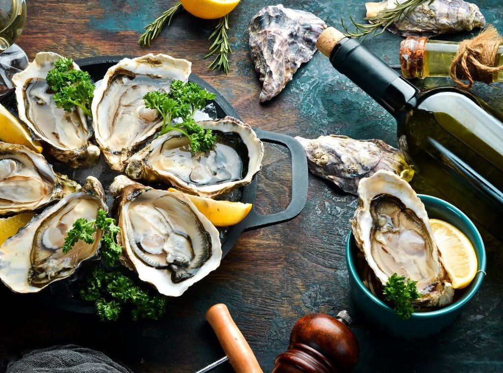 A plate of fresh oysters with wine