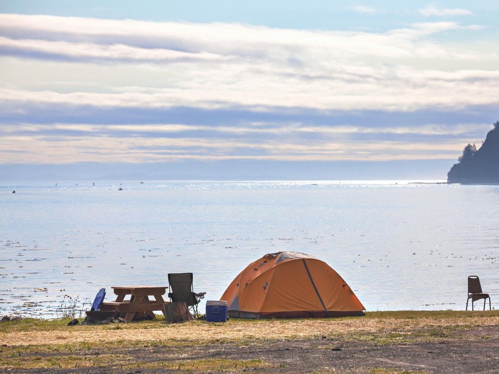 A tent camped at a waterfront location in Alaska