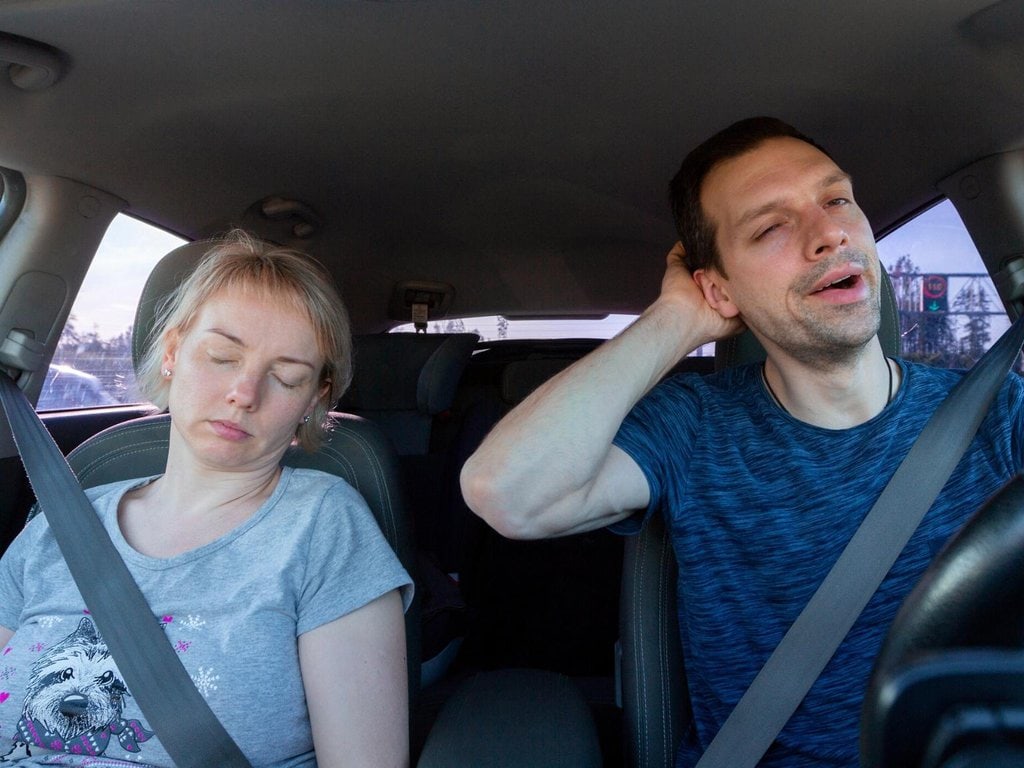 A tired couple on a road trip