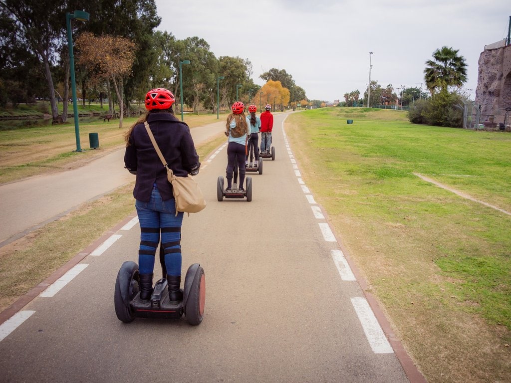 A group of people riding Segways