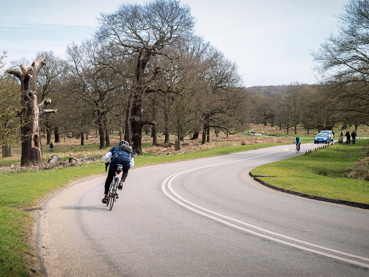 A man riding a bike along the Richmond Park cycling route