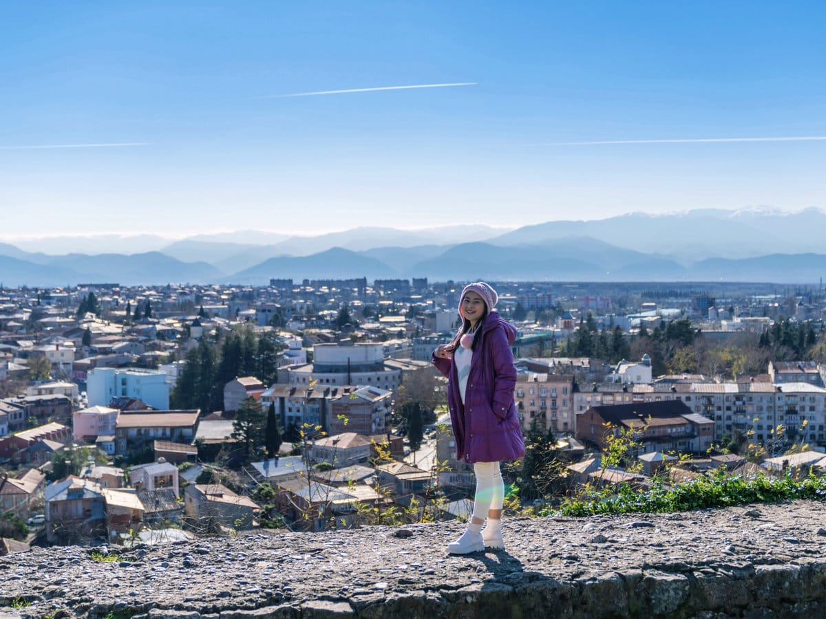 Standing in front of a view of the Kutaisi cityscape in Georgia