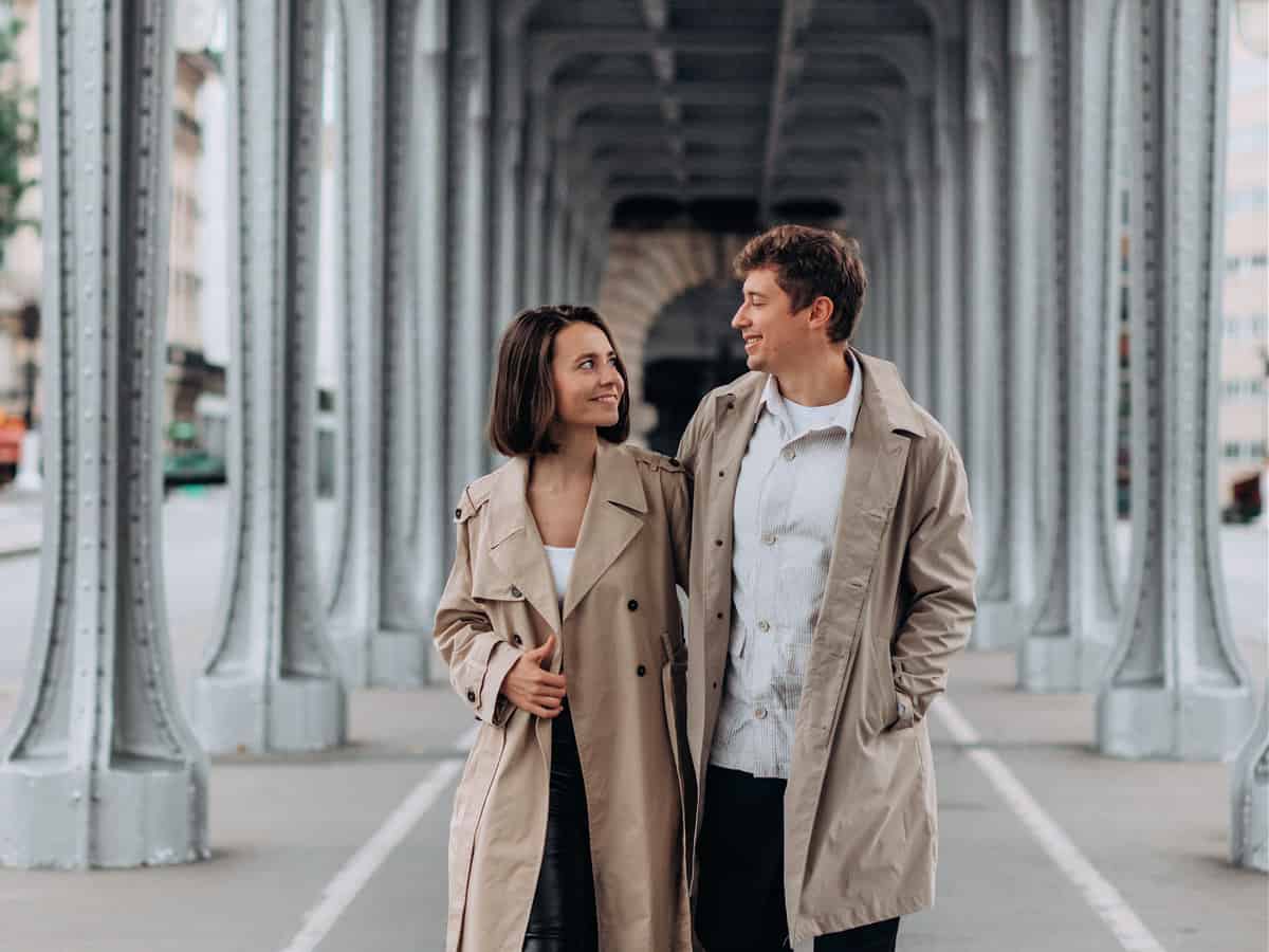 A Happy Couple Walking Under Bir Hakeim Bridge in Paris
