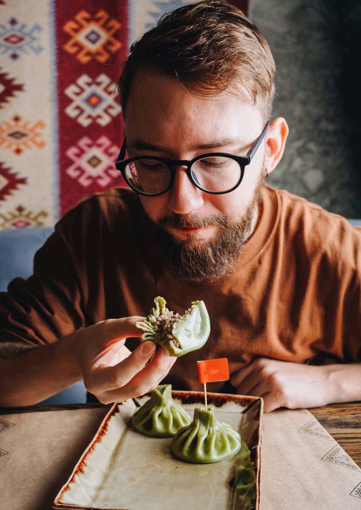 A man eating a khinkali