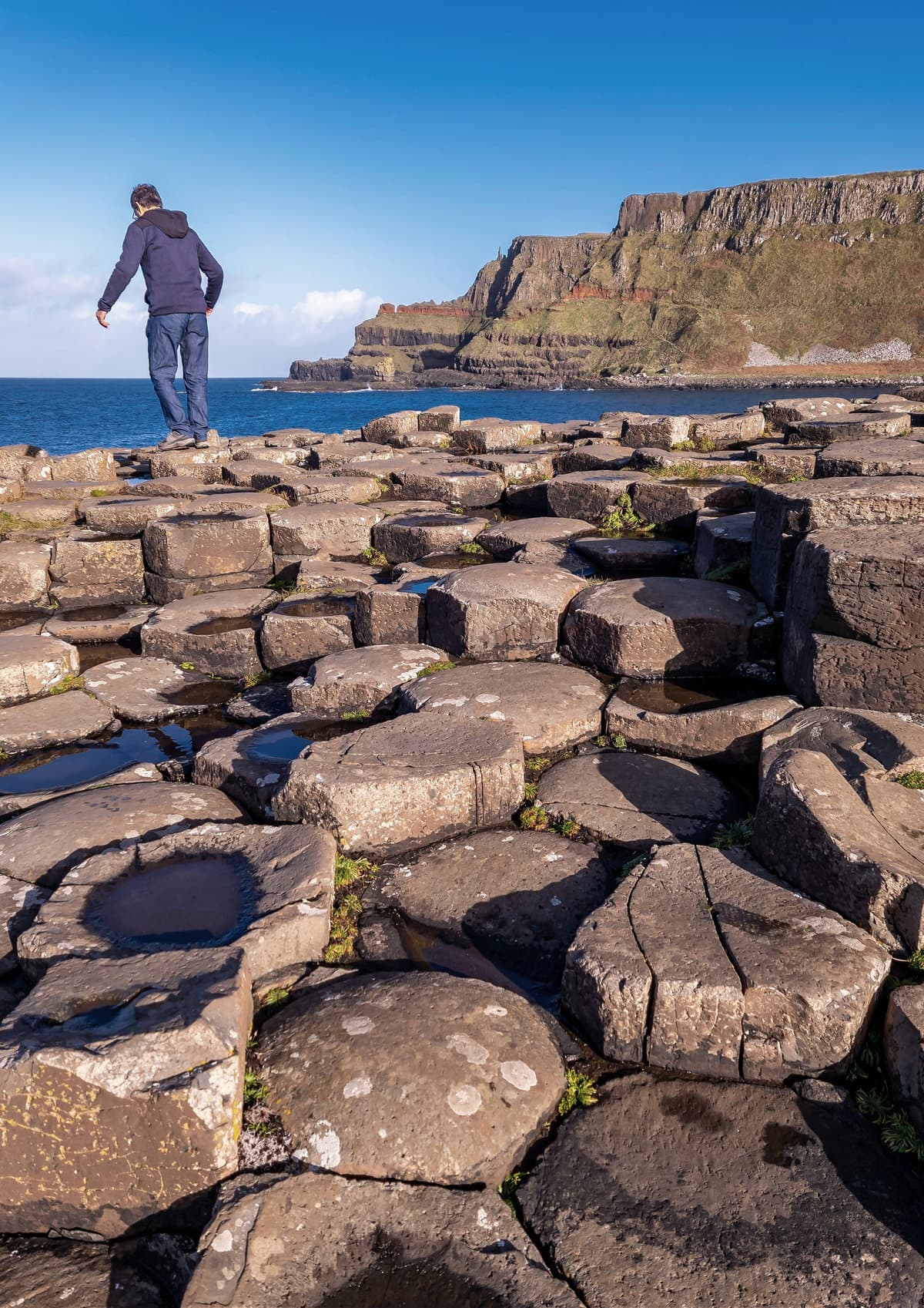 A tourist in the Giant's Causeway in Northern Ireland