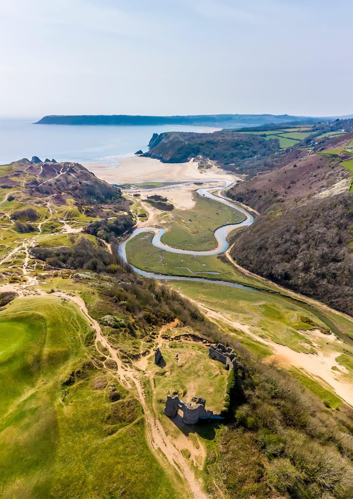 An aerial view of Three Cliffs Bay in Swansea, South Wales