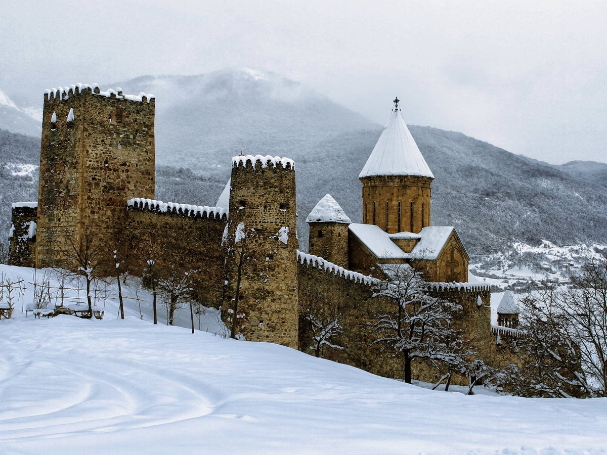 An ancient Georgian church covered in snow