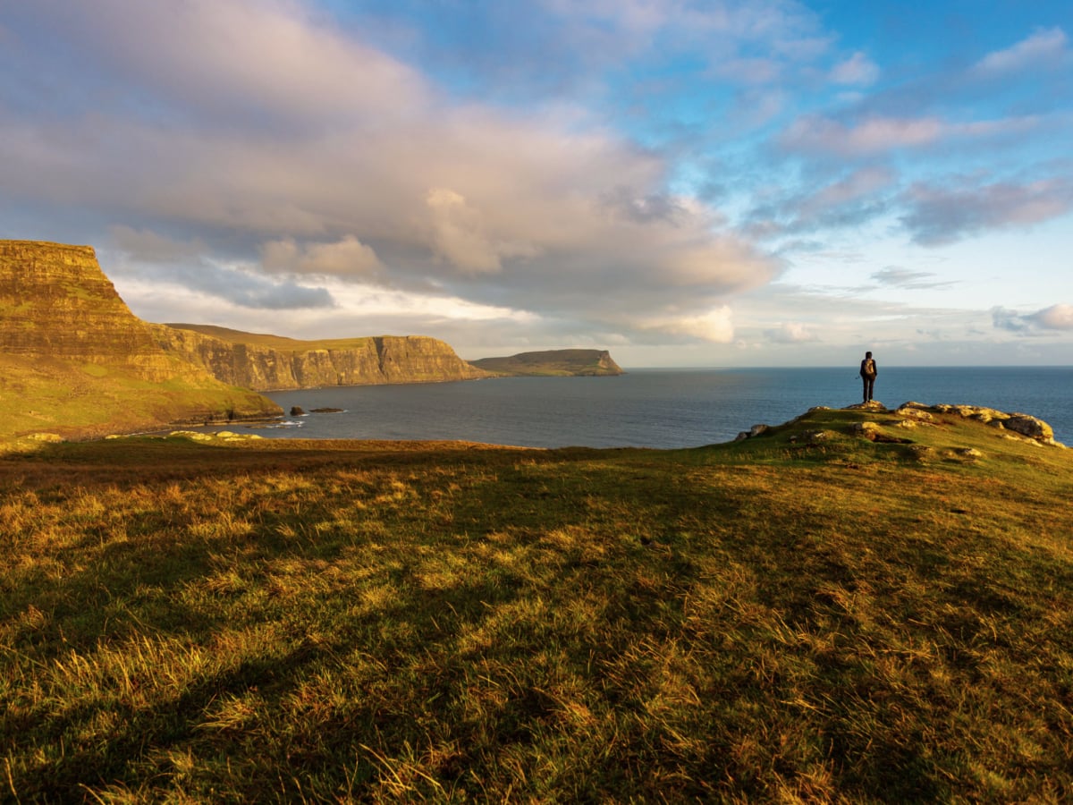 A tourist exploring the coastlines on the Isle of Skye