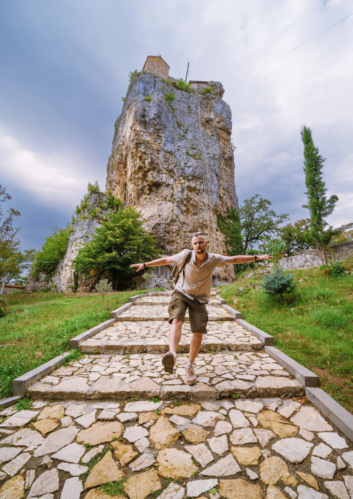 A happy tourist posing at the Katskhi Pillar in Georgia