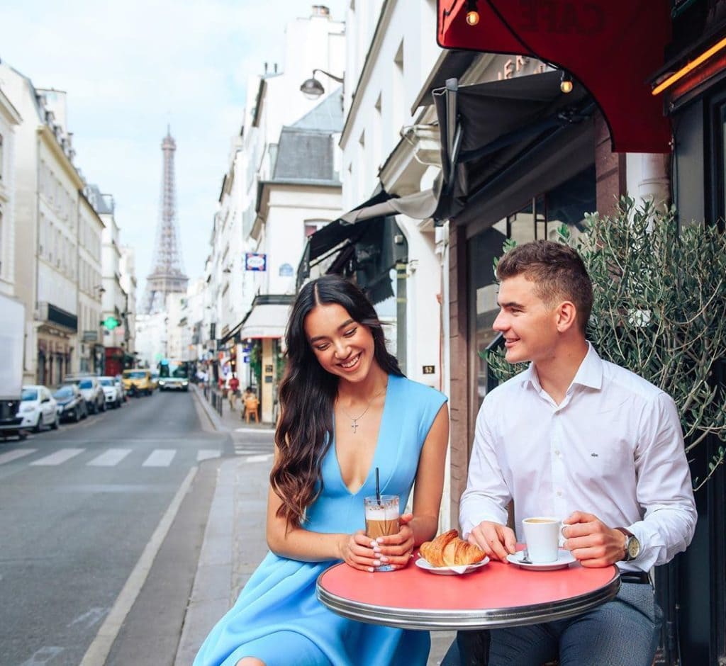 A loving couple sitting at a parisian cafe