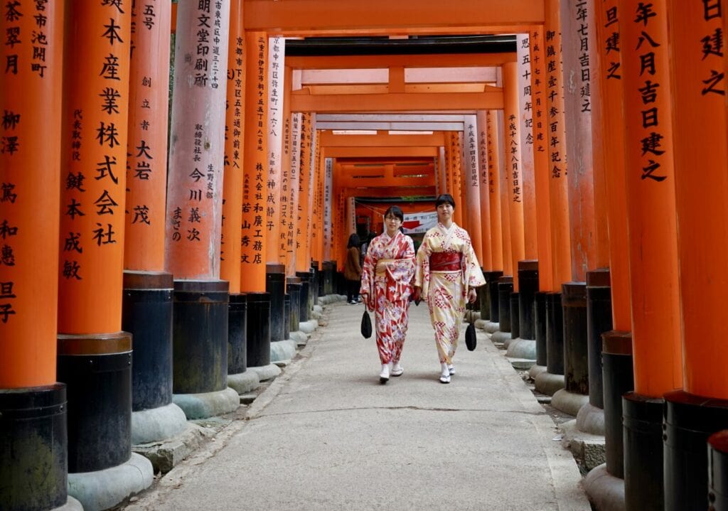 Strolling along the red gates in Fushimi Inari Shrine in Kyoto, one of the best things to do in kyoto, Japan