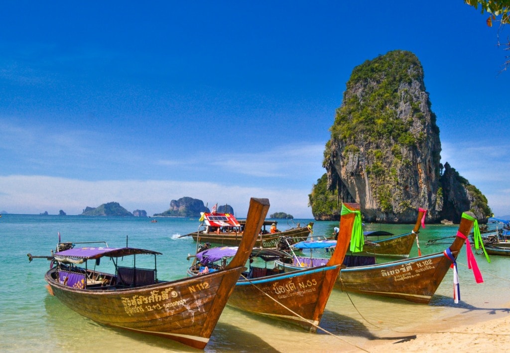 Boats on Phra Nang beach near rocks in Krabi