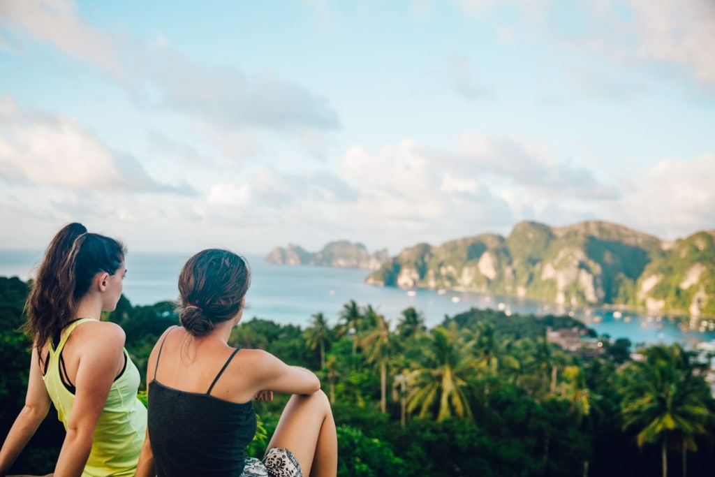 Women's sitting on a cliff in Thailand