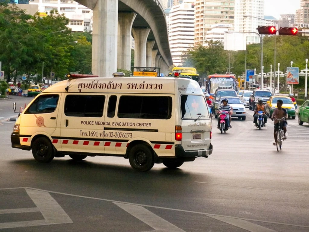 A Toyota Hiace ambulance of the Royal Thai Police Medical Evacuation Center tries to turn against the traffic on Rama IV Road Bangkok.