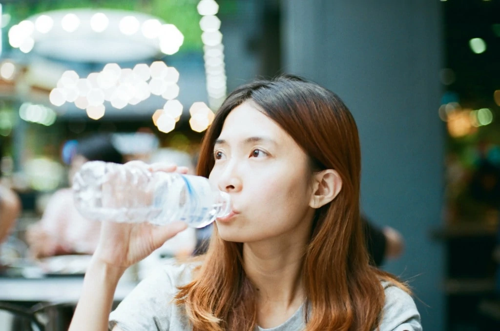 Woman drinking water in Bangkok
