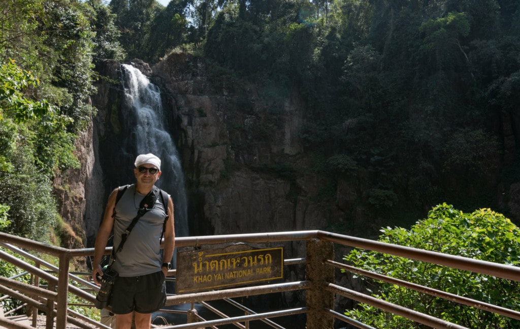 Man makes photo near waterfall in Khao Yai National Park in Thailand