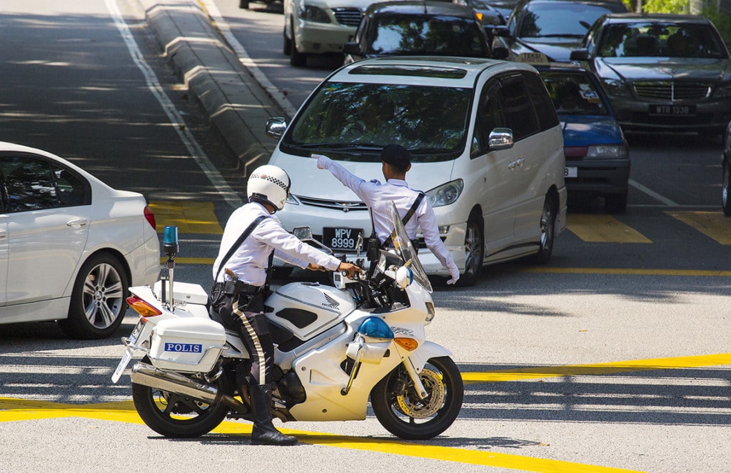 the policeman on a motorcycle on the road in Phuket