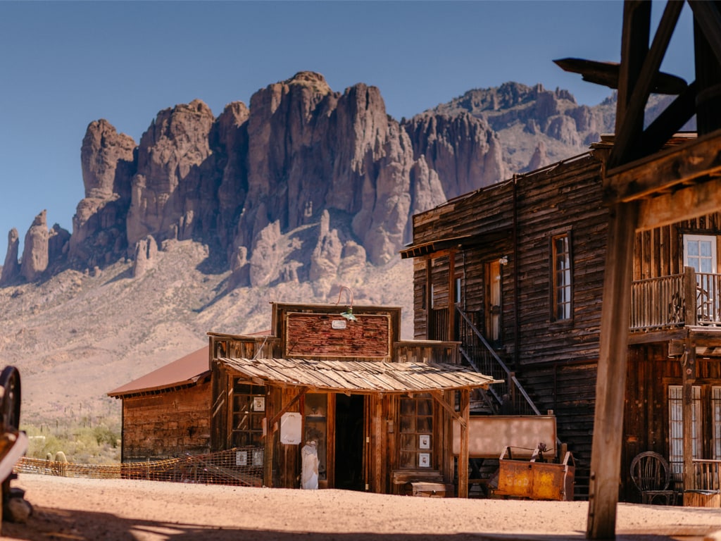 Old western wooden buildings in Goldfield gold mine ghost town overlooking the Superstition Mountains, Arizona