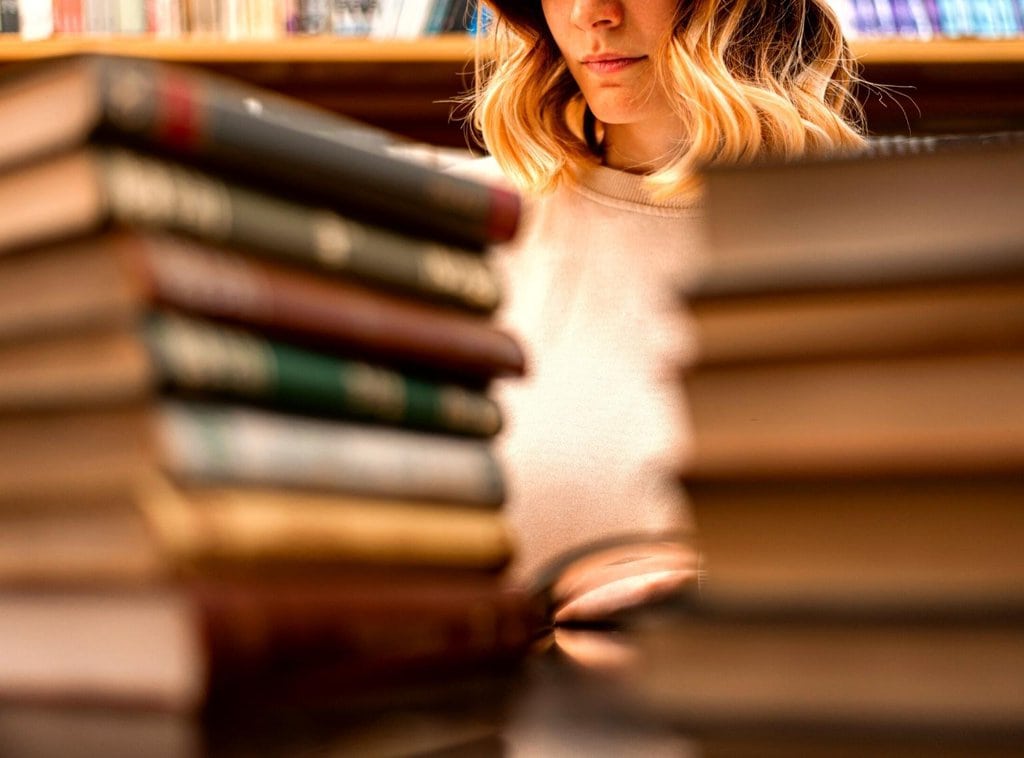 A girl surrounded by books