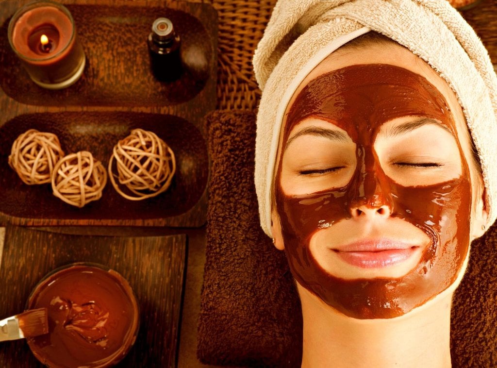 A woman getting a chocolate facial mask treatment